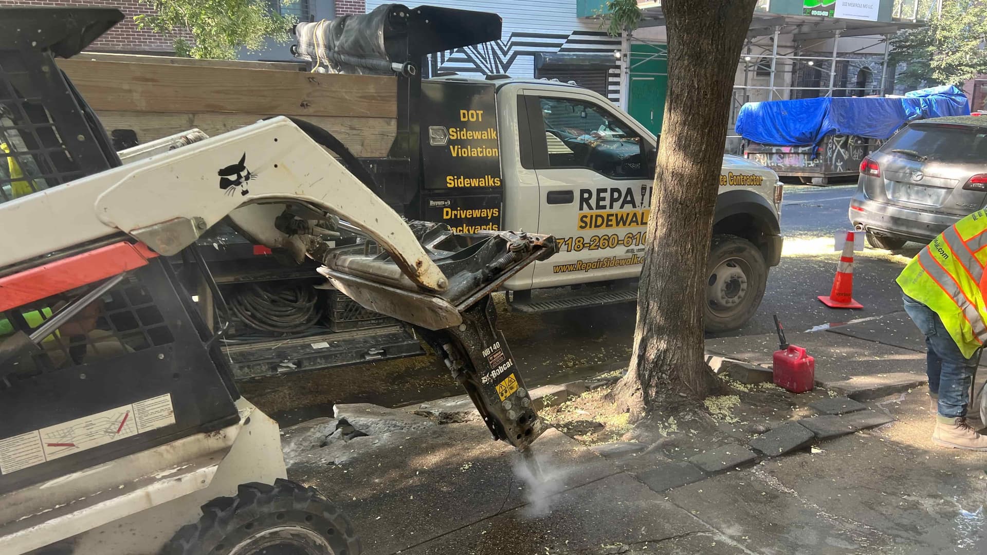 Breaking concrete during sidewalk repair in NYC