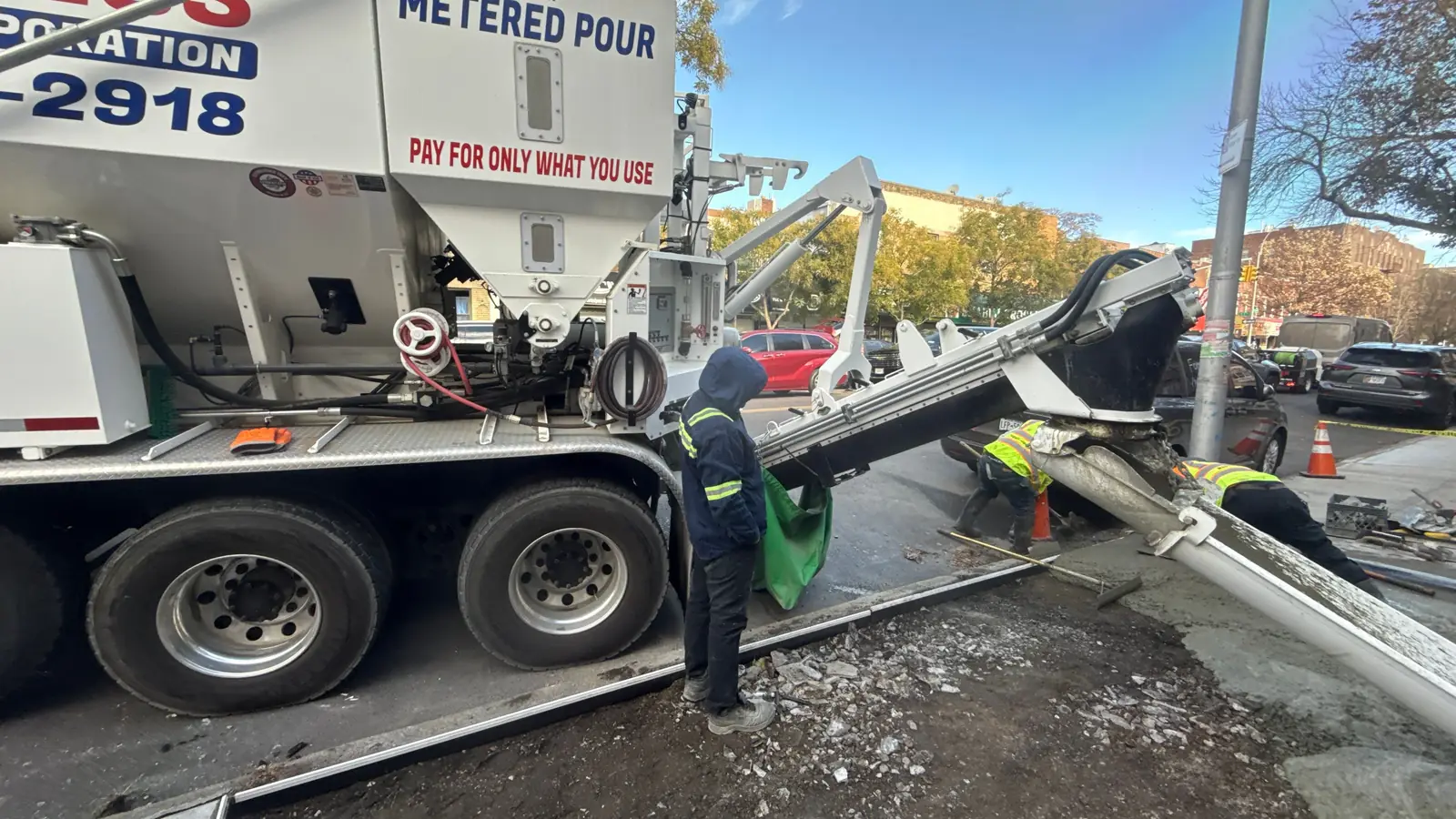 Ready mix concrete truck and crew performing sidewalk work in NYC