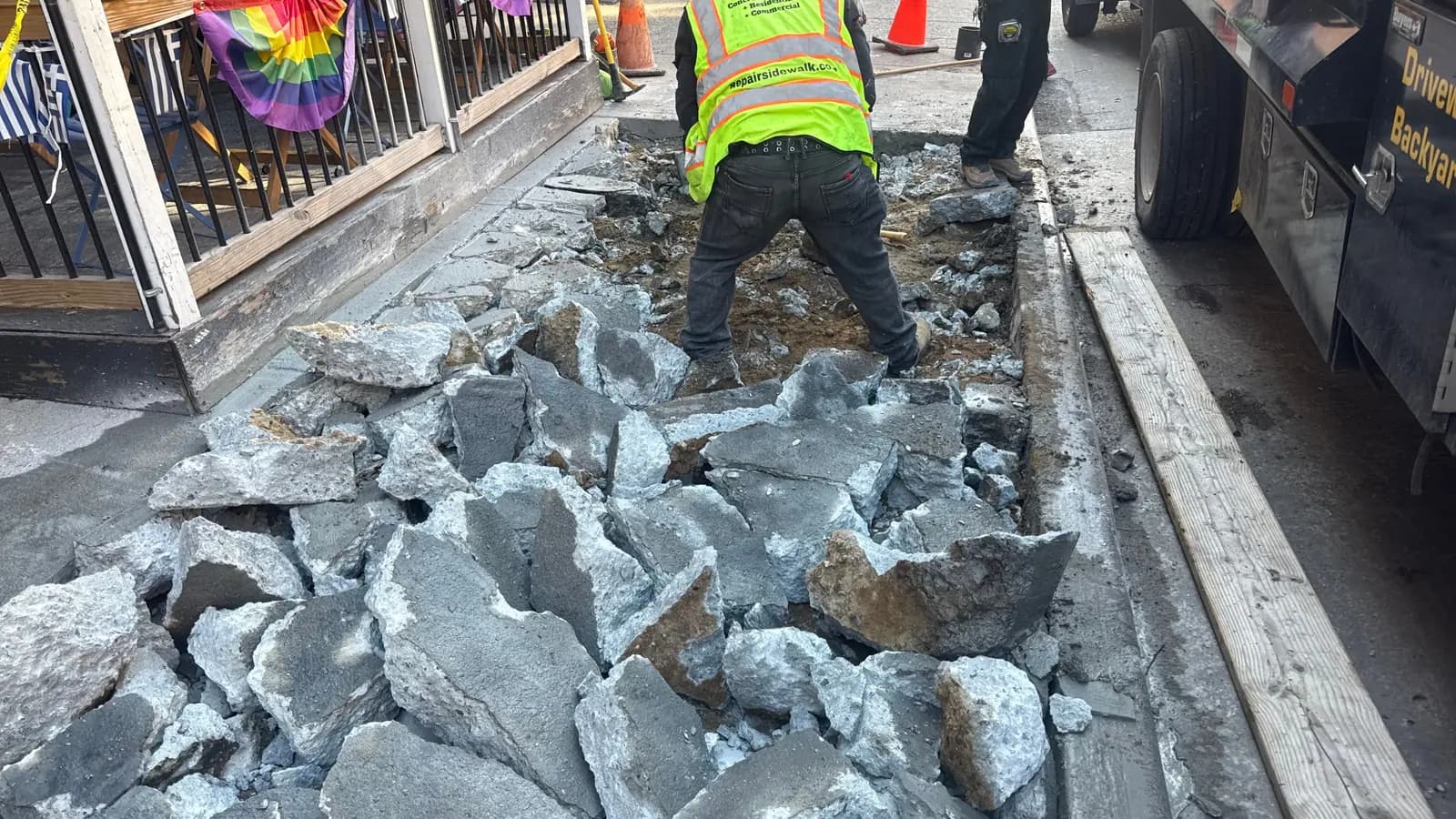 Broken concrete removal during sidewalk repair in NYC