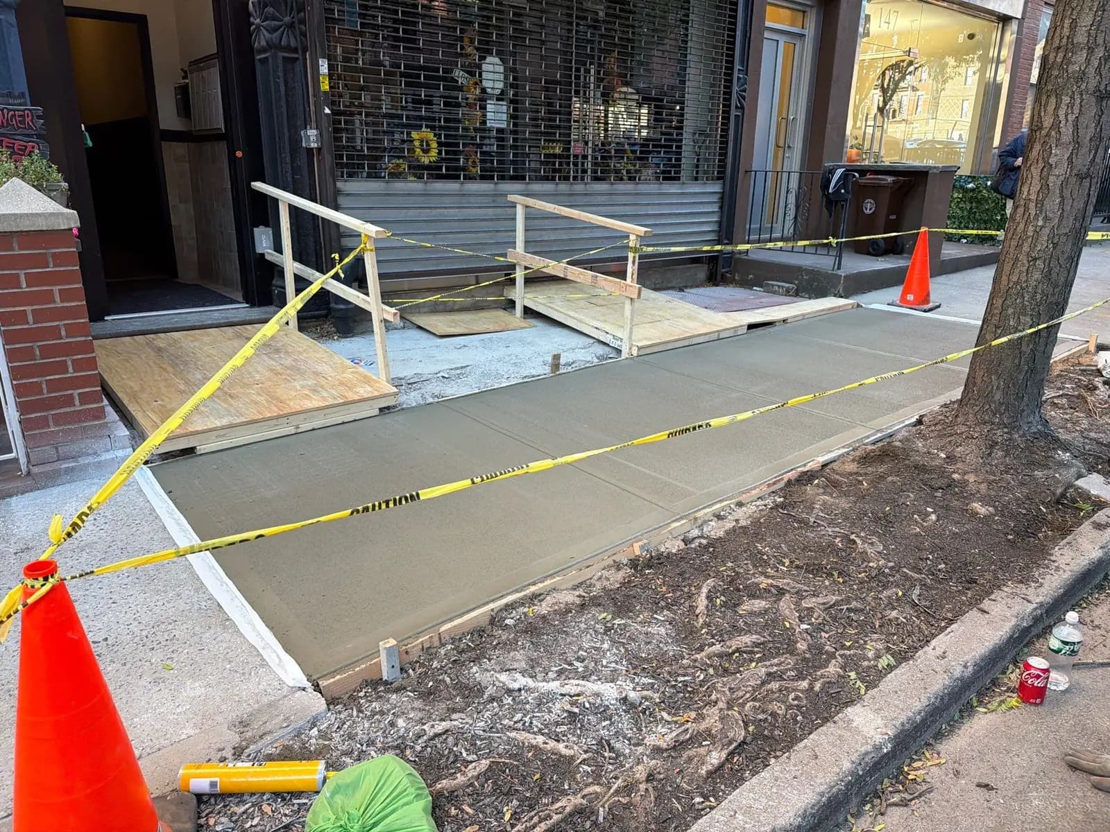 NYC curb and sidewalk concrete restoration work outside a storefront